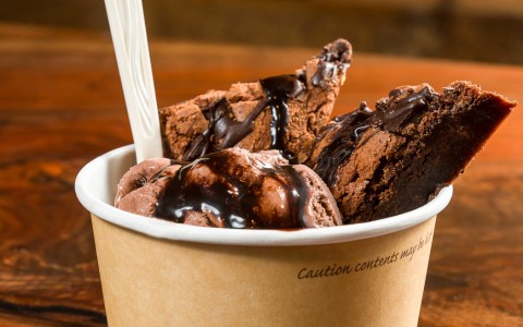 Container with chocolate ice cream, brownie & fudge