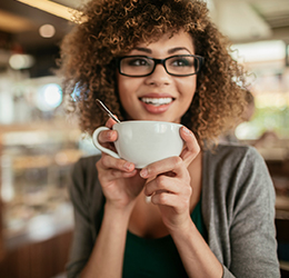 women holding a coffee cup