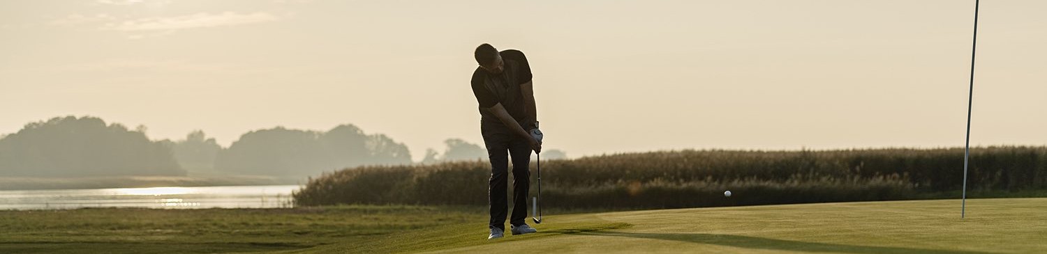 man playing golf on course 