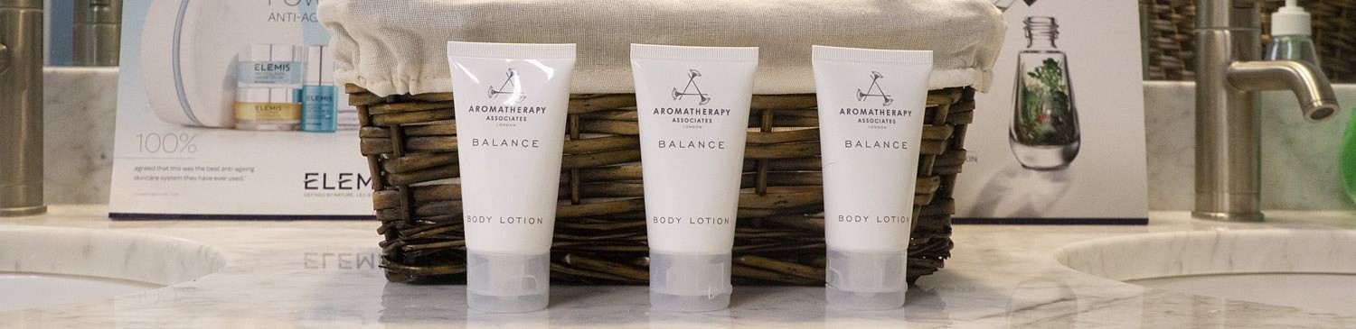 lotion in front of a whicker box