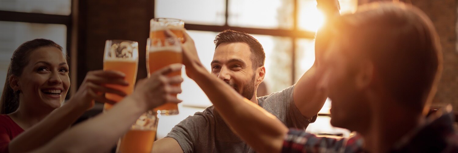 Group of friends toasting with beer