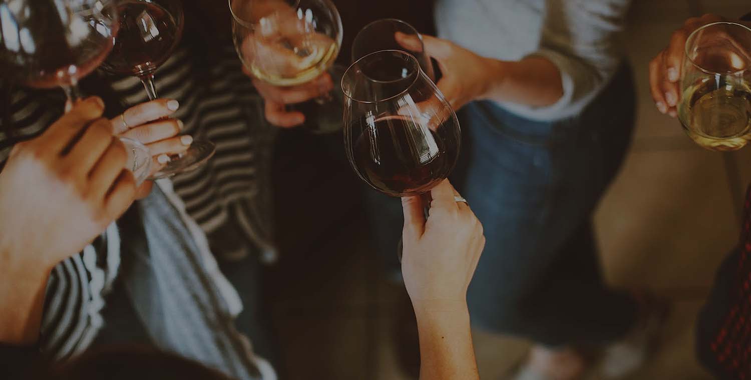 up-close image of people holding their wine glasses