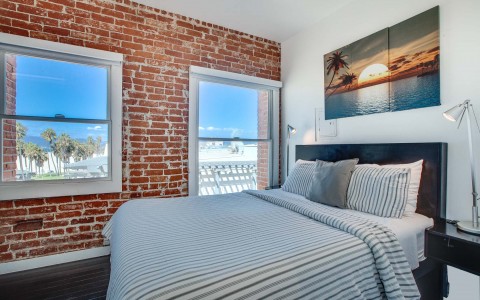 bright room with brick layer accent wall 