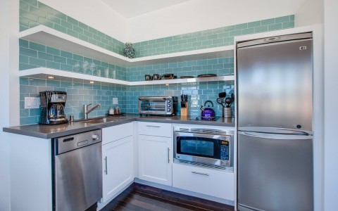 kitchenette with light green tiles in suite 