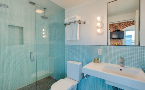 bathroom with blue tiling and glass shower 