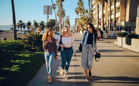 three women walking on the side walk 