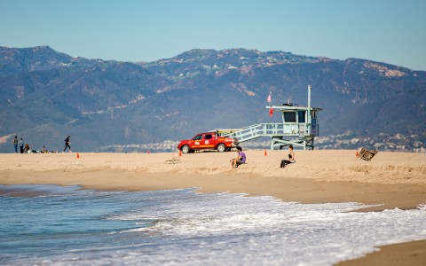 mountainous view from the beach with a lifeguard stand 