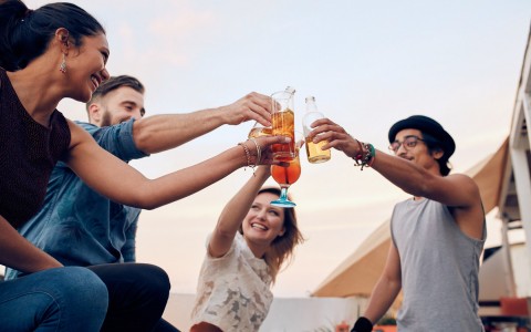 four people enjoying cocktails 
