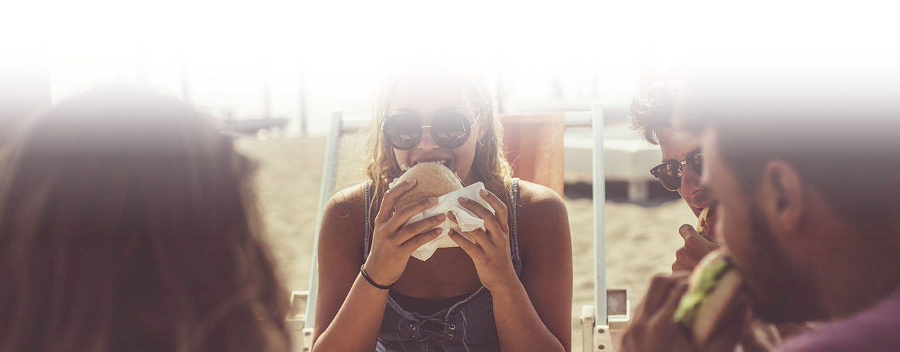 people enjoying fresh sandwiches outside