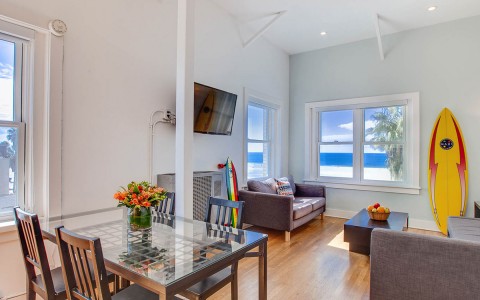 living and dining area with TV and view of the beach