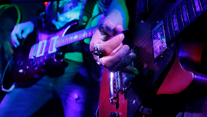 close up of guitars being played live