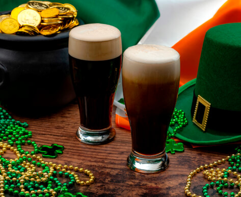 beers next to green and gold beads and a green hat