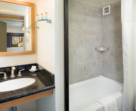 cosmopolitan twin bathroom with sink and standing bathtub shower