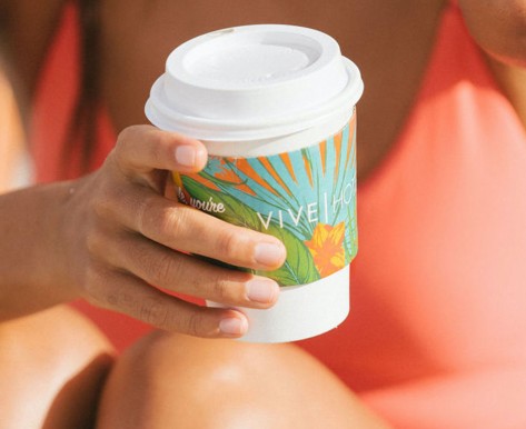 woman holding vive hotel coffee cup 