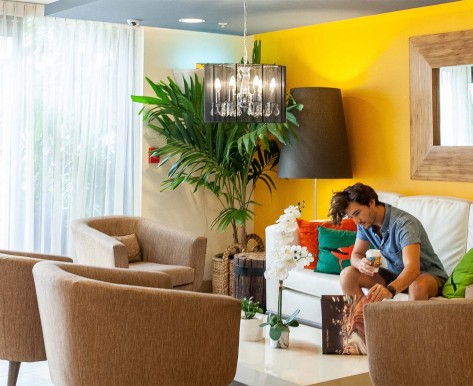 man hanging out in his nice guest room