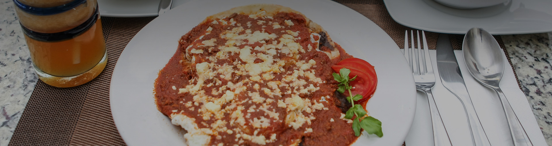 plate of enchiladas with red sauce and cheese