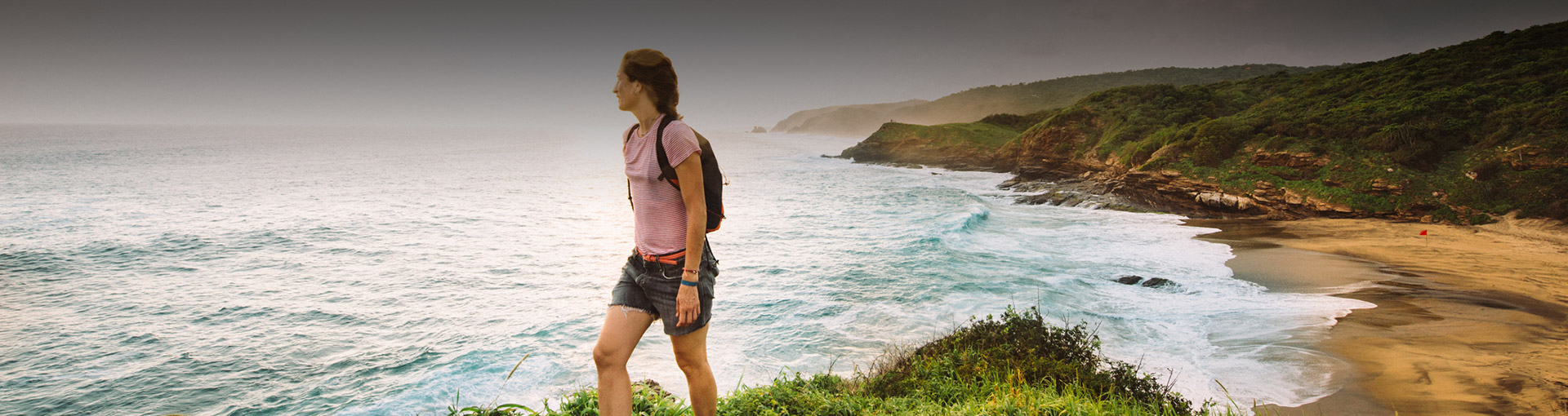 women hiking on beach