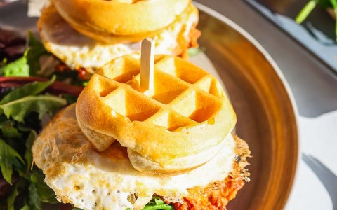 fried chicken and waffle sandwiches on a plate