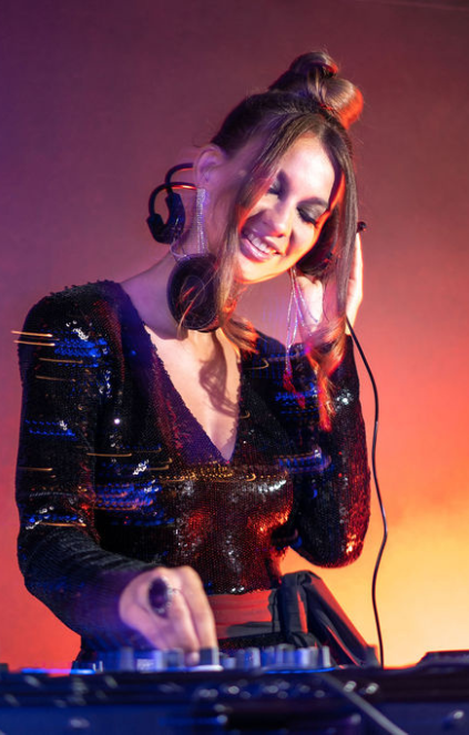 girl DJing with headphones on