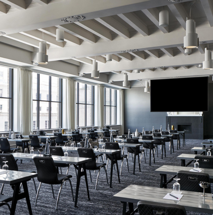 Elevation meeting space with multiple desks and black chairs