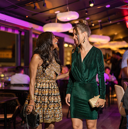 2 women laughing and walking