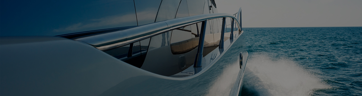 close up of the side of a yacht being driven off