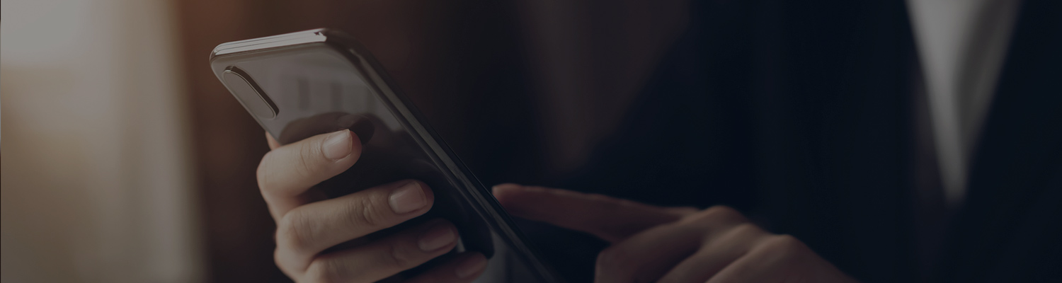 man's hands holding a phone