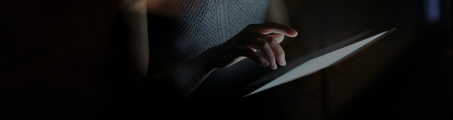 view of a woman's hands holding a tablet