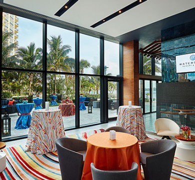 Tall chairs & tables scattered in a room with screen