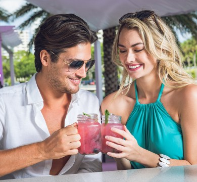 Couple enjoying cocktails outdoors