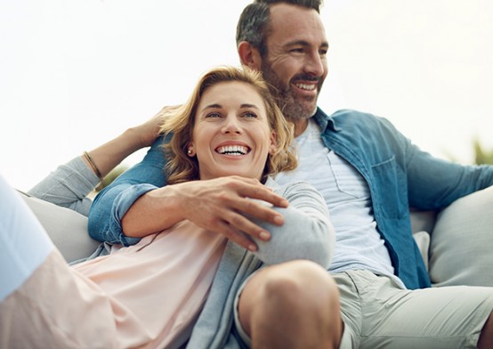 couple cuddling and smiling