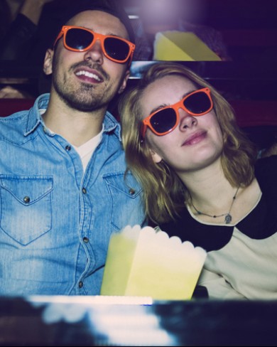 couple in orange glasses at movie theater