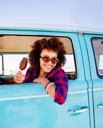 woman driving van eating ice cream