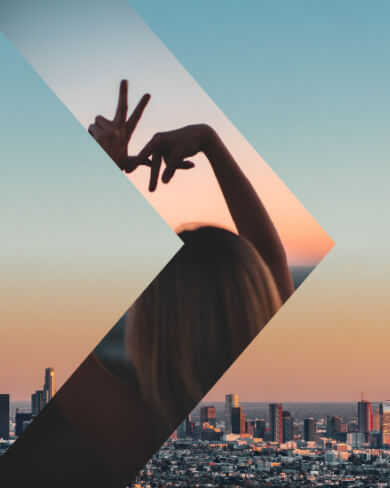 person making LA sign with their fingers with city view overlay