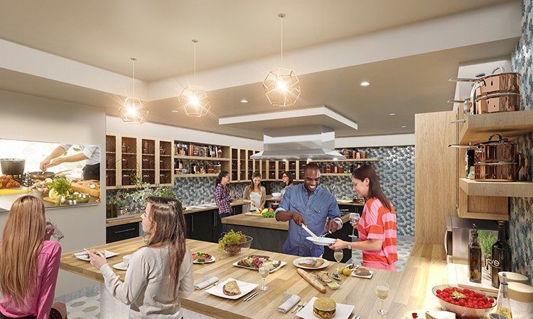 group of people in a large kitchen doing various cooking tasks