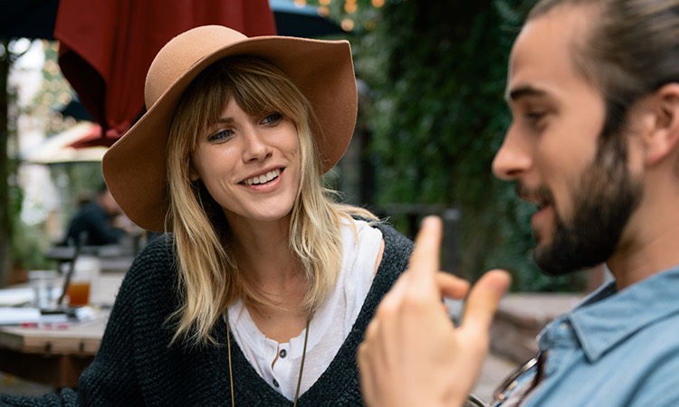 man and woman sitting outside at a restaurant
