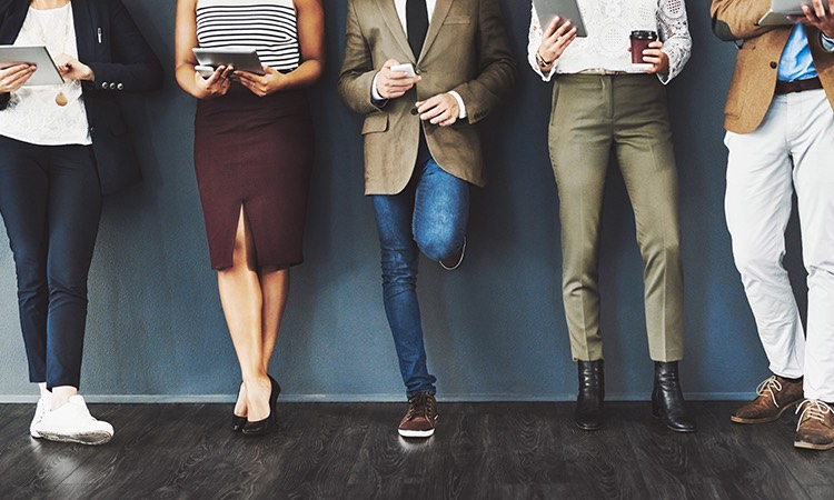 group of business people standing against a wall