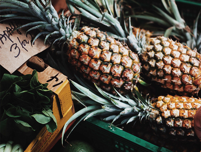 close up view to pineapples at a market 