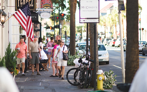 Group of people walking down Charleston streets
