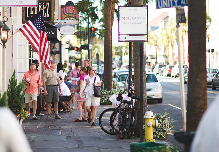 Group of people walking down Charleston streets