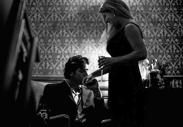 Man kissing woman's hand