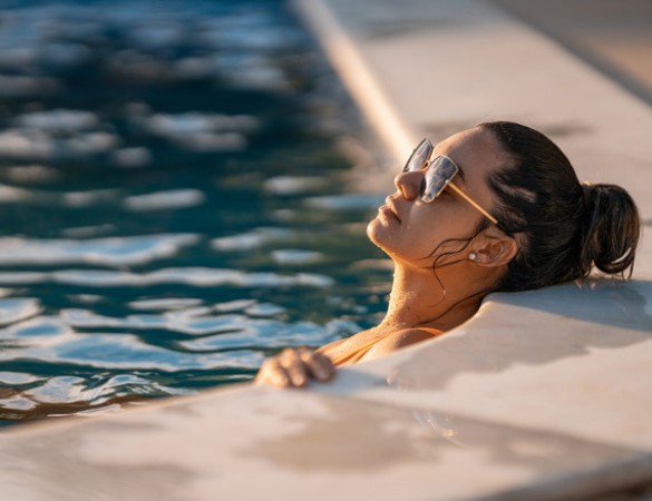 woman wearing glasses relaxed inside the pool
