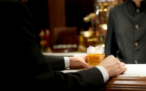 bartender serving a drink to guest