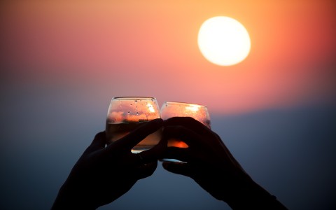 toasting while outside at sunset