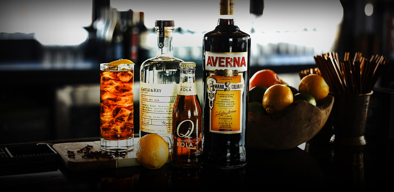 darkened image of multiple bottles for a cocktail