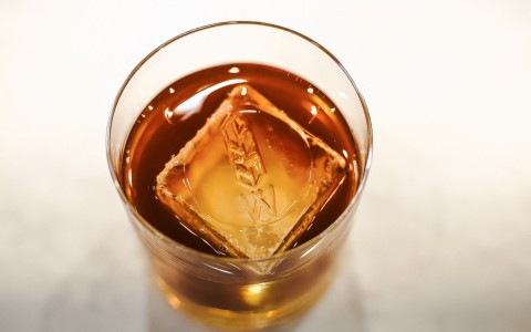 old fashioned cocktail with one large ice cube