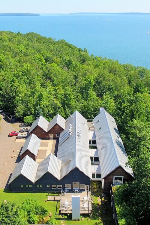 aerial view a property in the middle of the nature and the sea at daytime