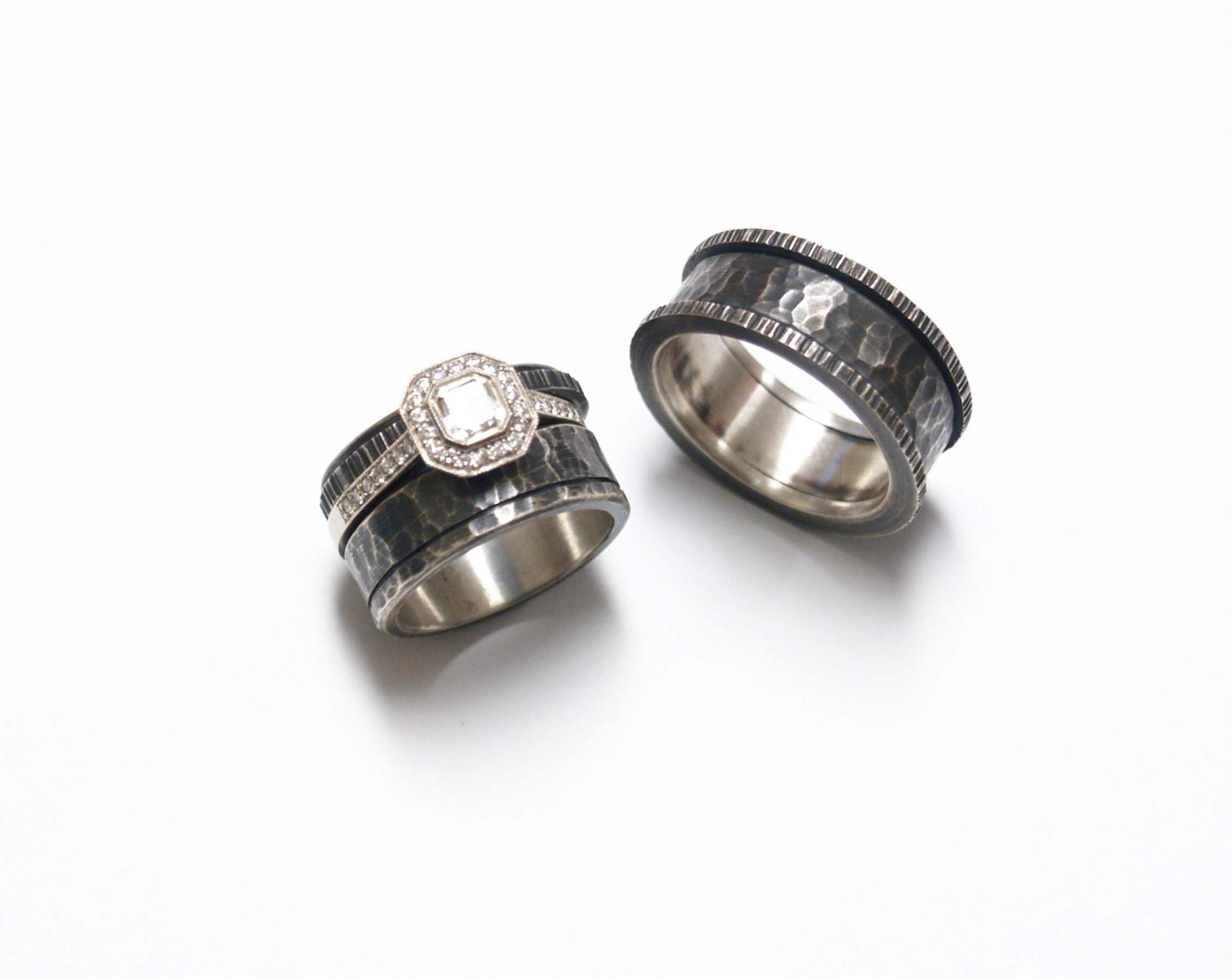 Top view of two metal rings one with a white diamond 