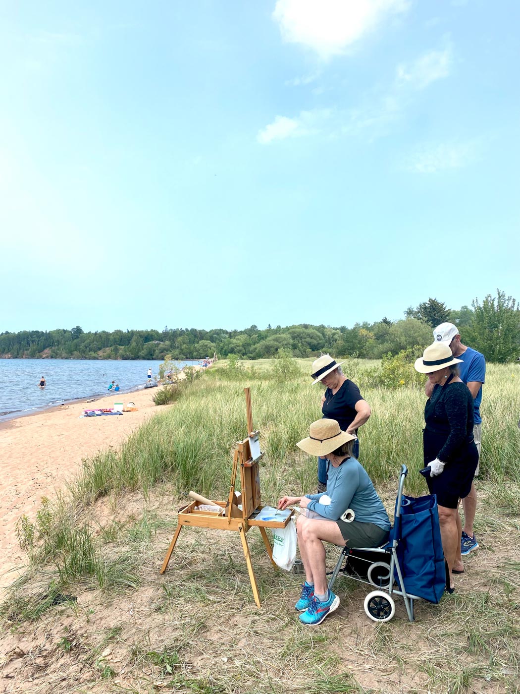 people gathered painting at the beach during the day