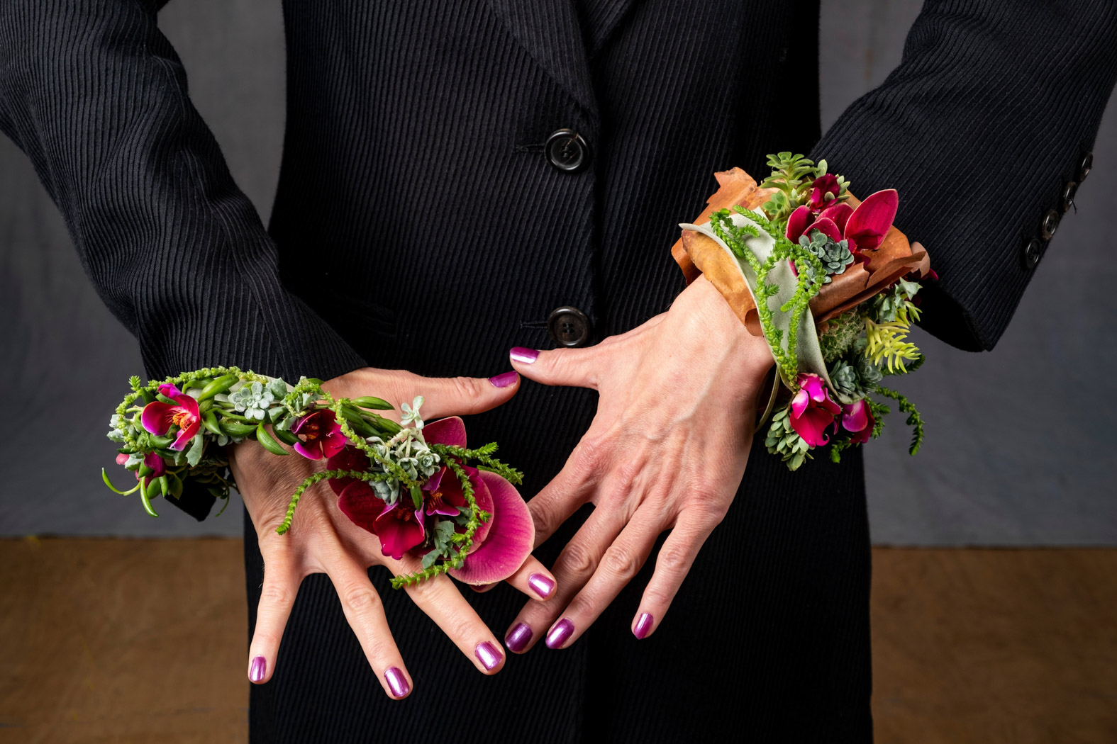 a ladys hands with flowers on her wrist